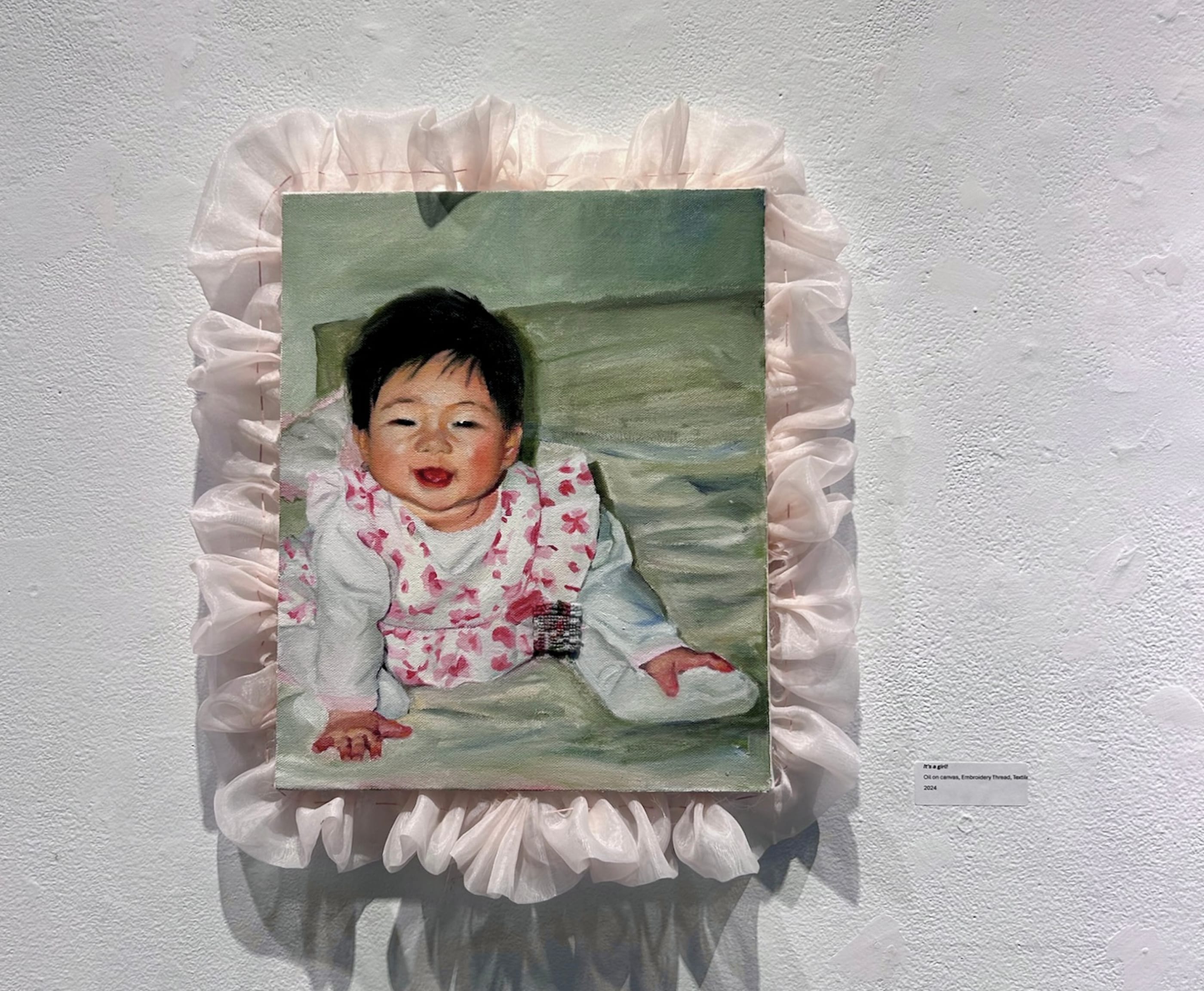 Framed baby painting on a gallery wall